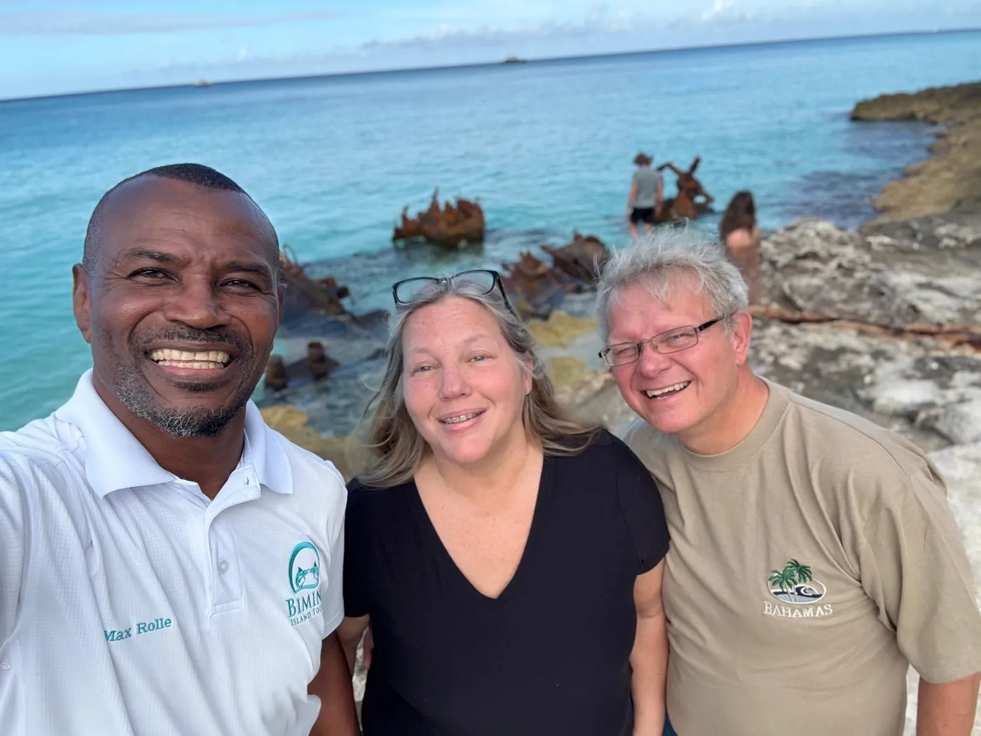 Bimini Island Tours guide Max Rolle with two guests at the SS Sapona wreck site during a tour